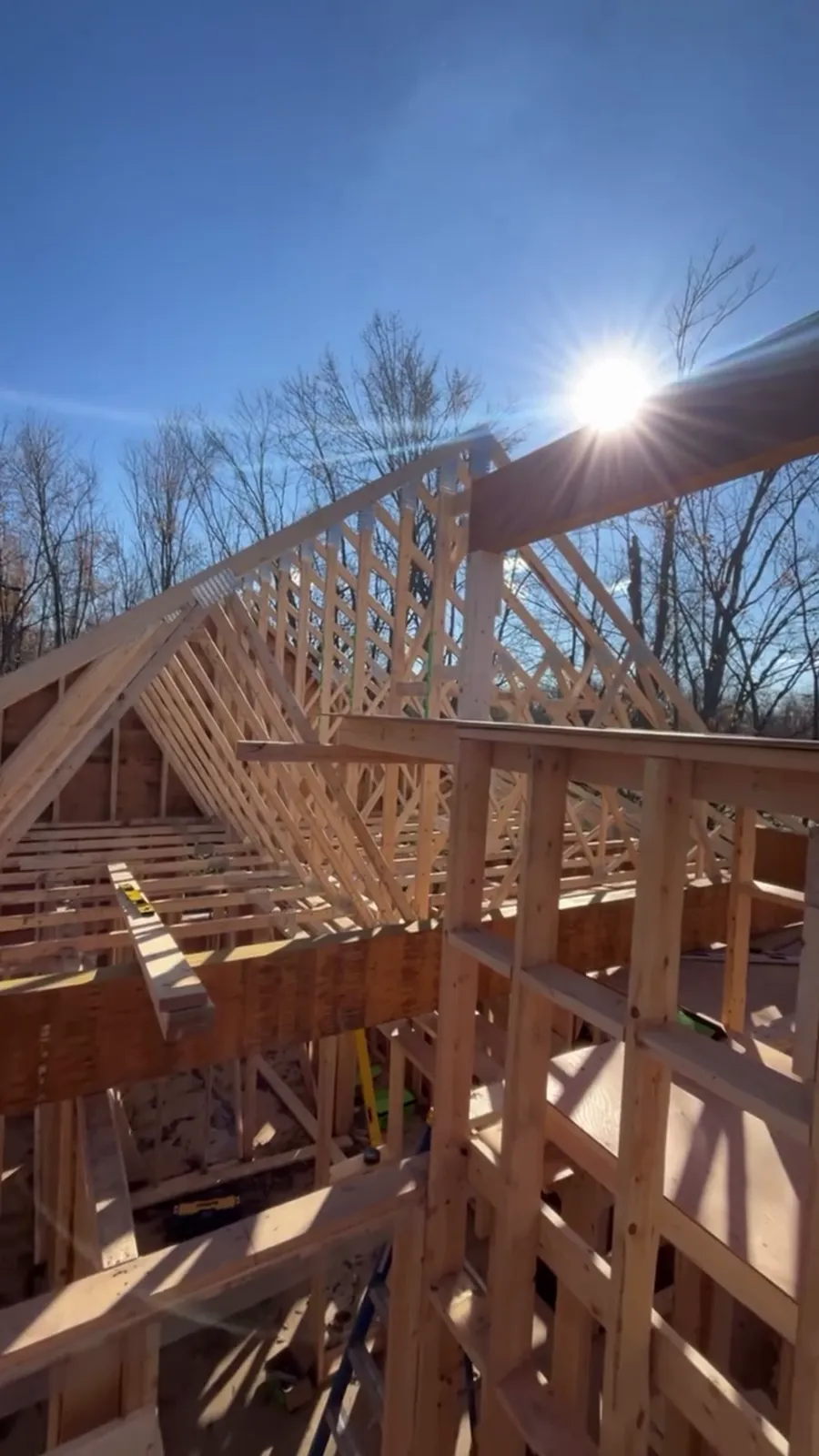 Exposed roof trusses against a blue sky